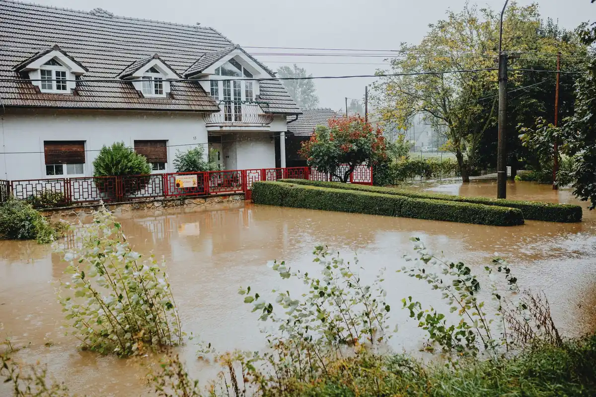 A suburban house surrounded by floodwater after heavy rain