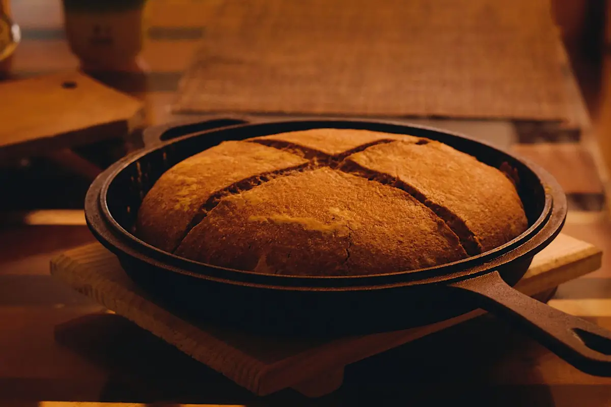 A round loaf of bread baked in a cast iron skillet