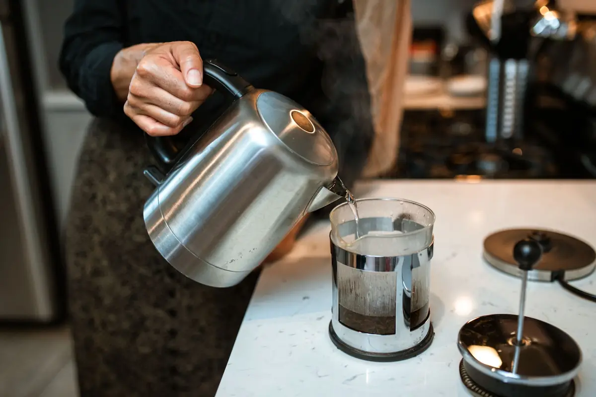 Hot water poured over coffee grounds in a French press