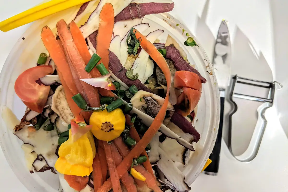 Vegetable peels and scraps on a cutting board