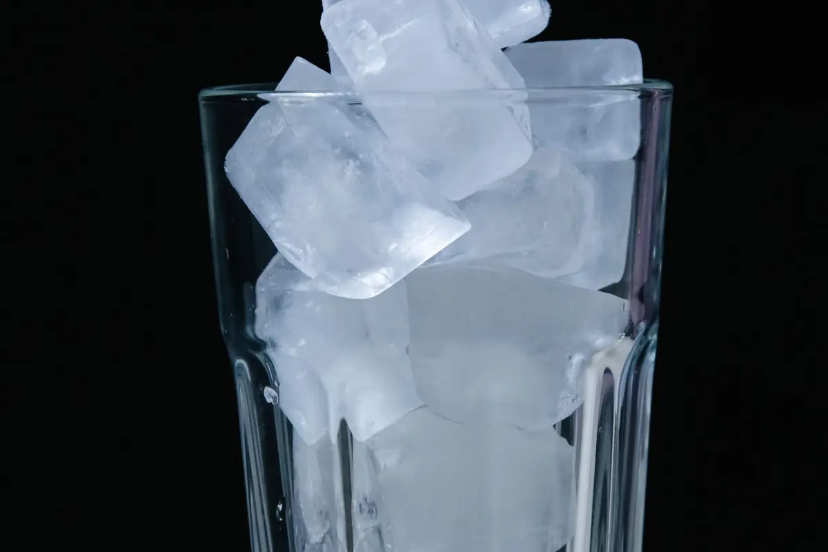 A tall glass packed with ice cubes