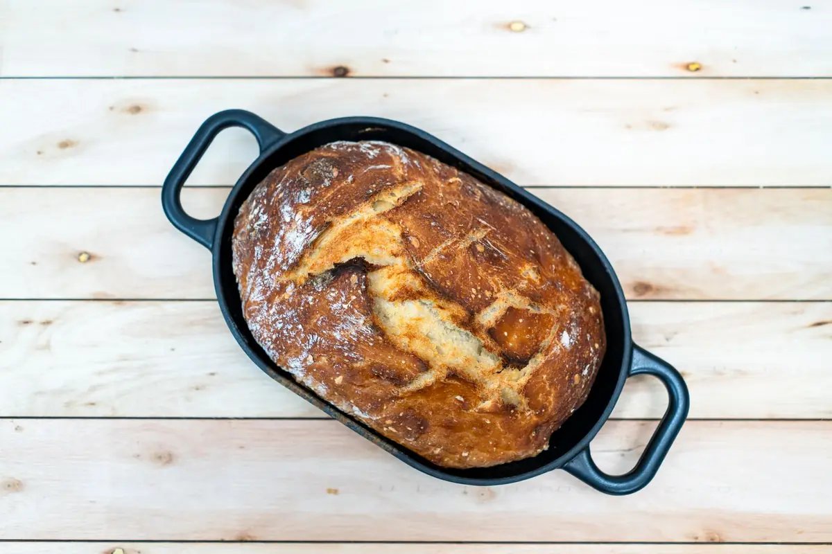 Looking down at a freshly baked sourdough loaf in a Dutch oven