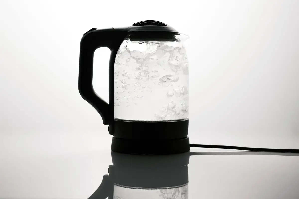 A glass electric kettle on a kitchen counter