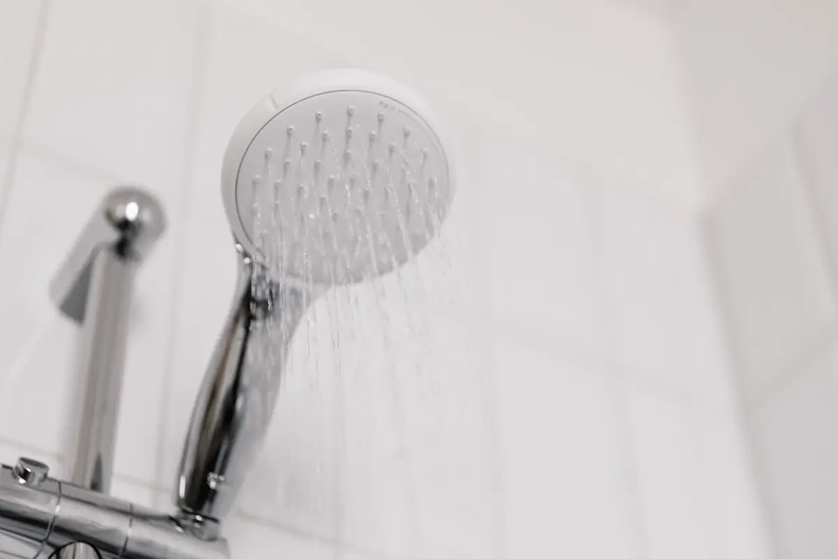 Water running from a handheld shower head