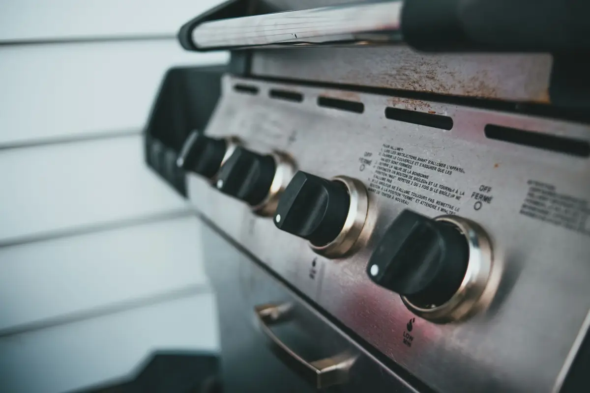 A side view of a gas grill control panel