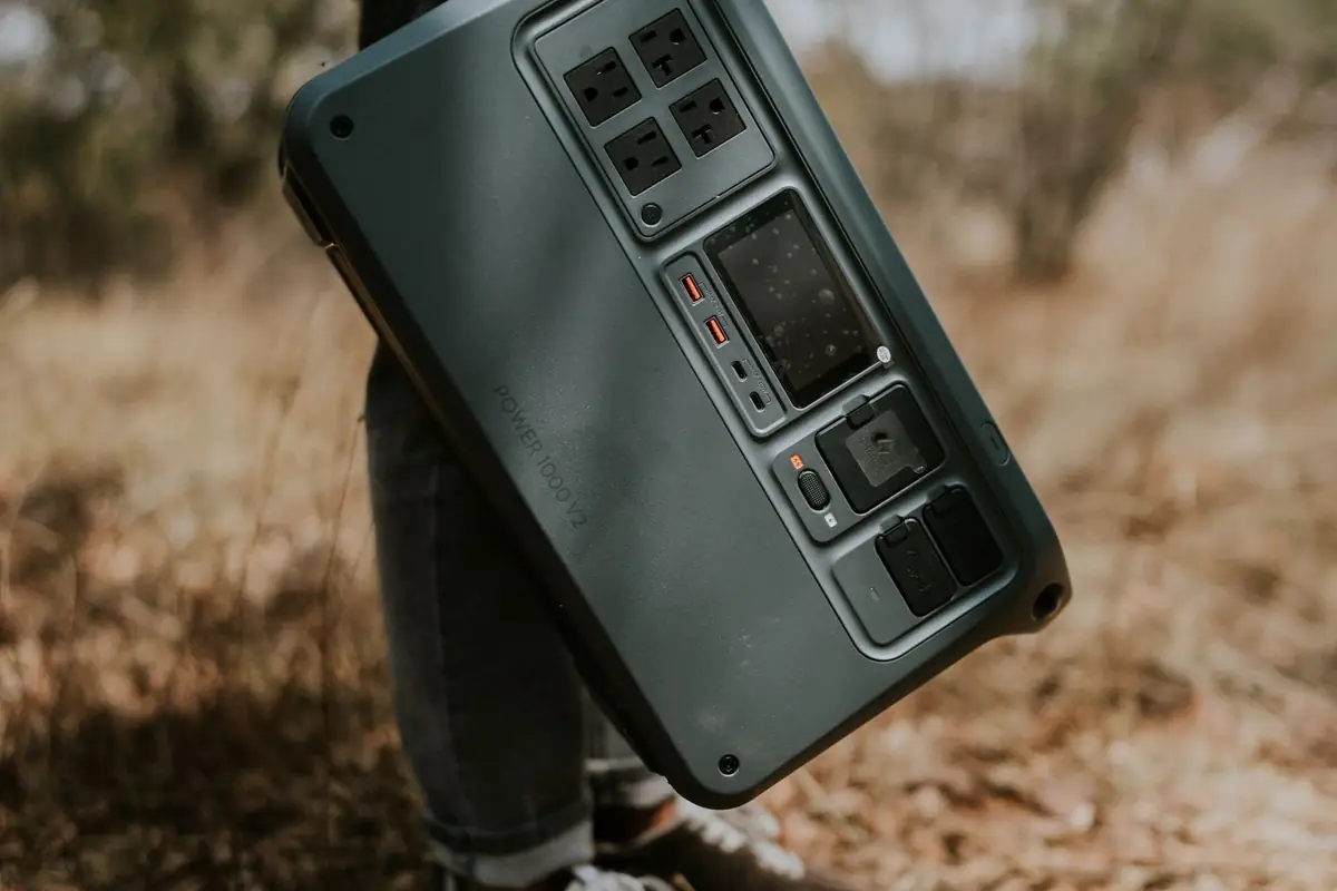 A person carrying a portable power station outdoors
