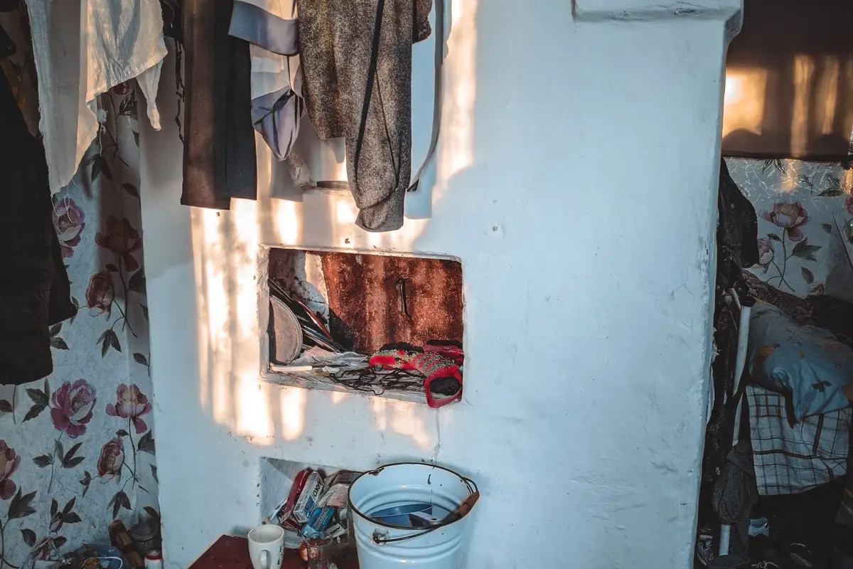 Clothes hanging to dry indoors in a sunlit room