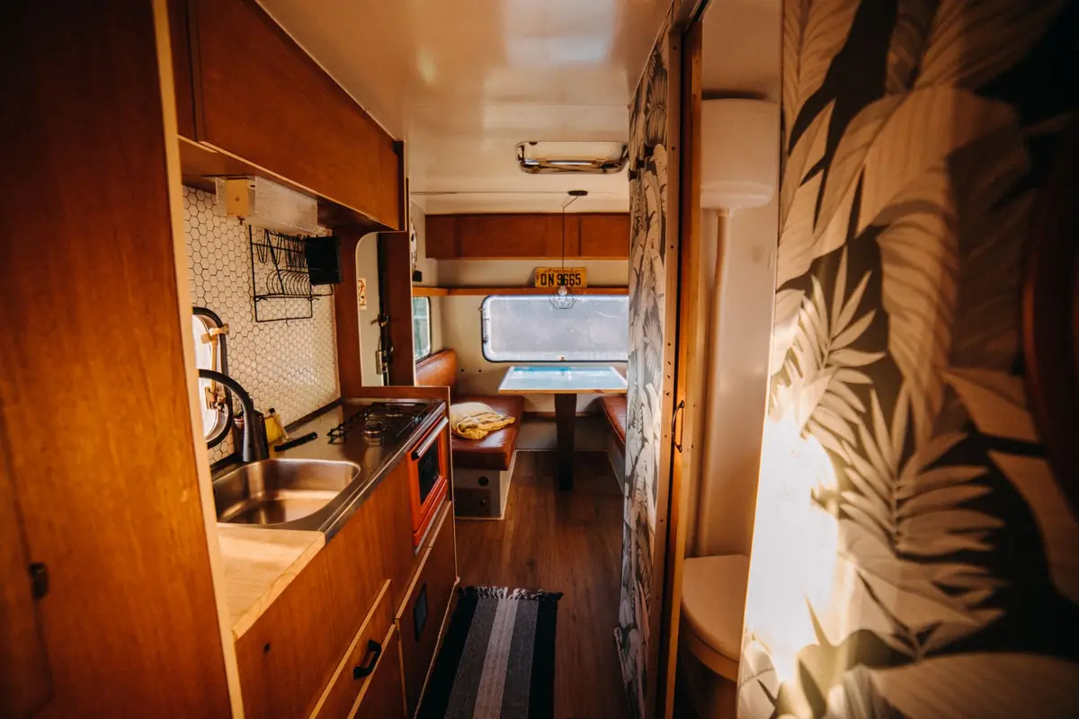 A narrow camper kitchenette with a small sink