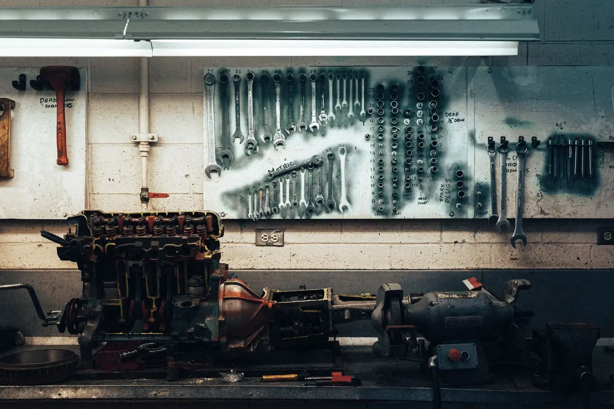 Wrenches hanging on a wall board above a workbench