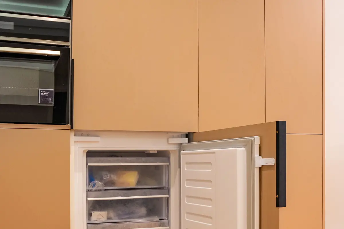 An open freezer with pull-out drawers in a kitchen