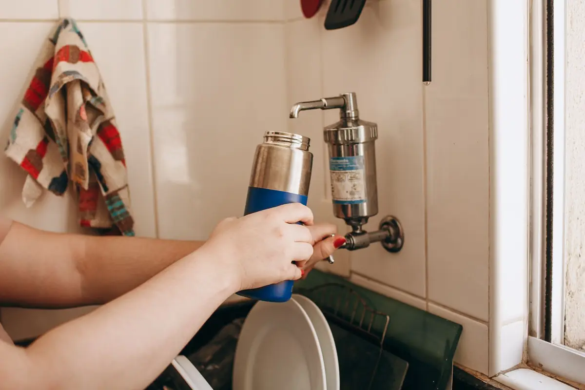 Filling a bottle from a filter mounted on a kitchen faucet