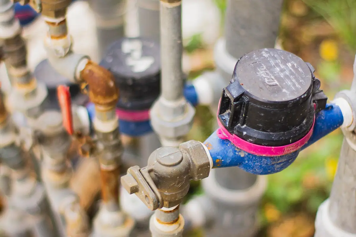 Water meters and shutoff valves on a row of pipes
