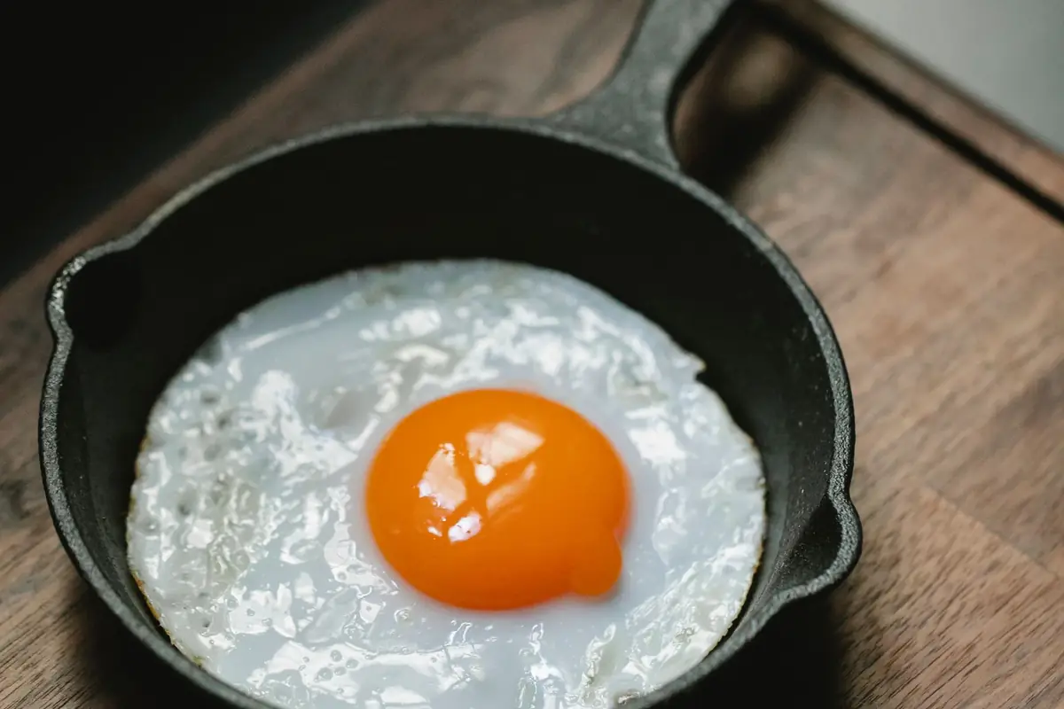 A fried egg in a small cast iron skillet
