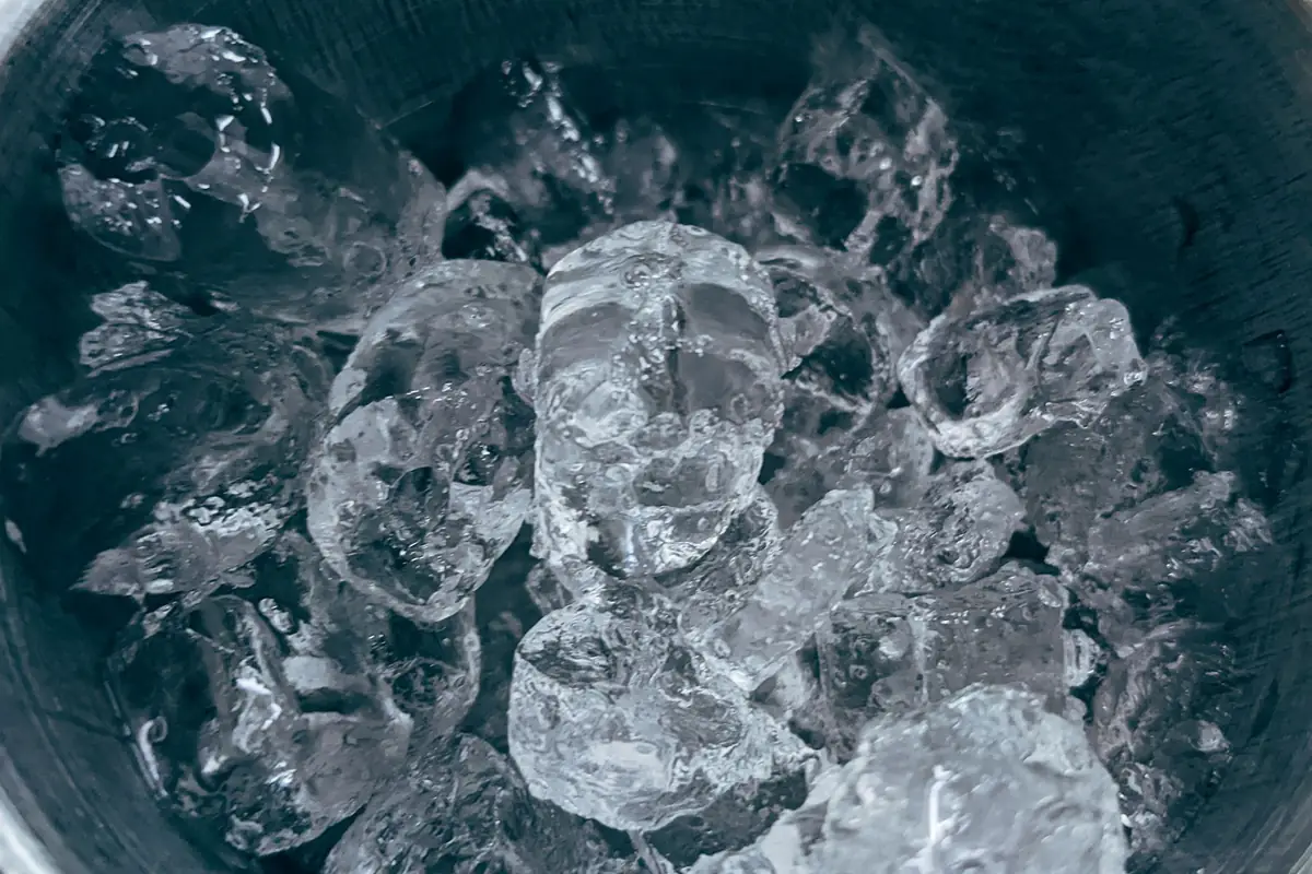 Ice cubes in a metal bucket, seen from above