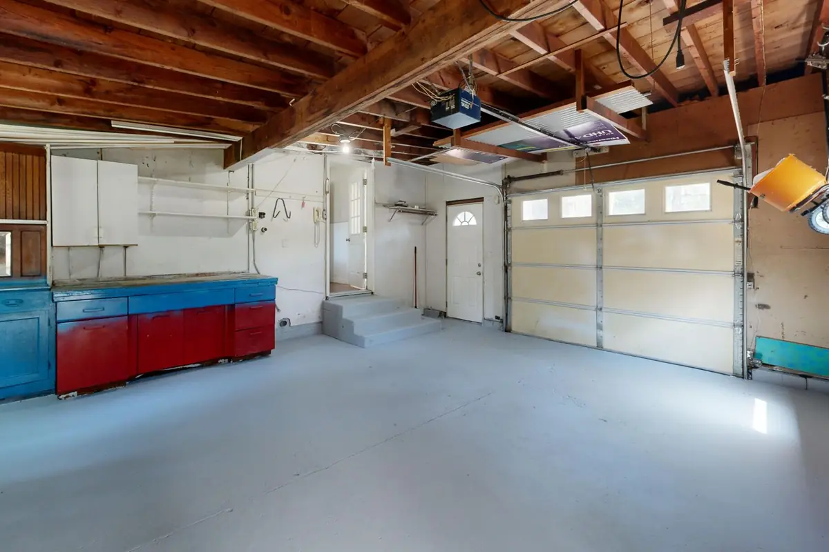 An empty garage with storage cabinets along one wall