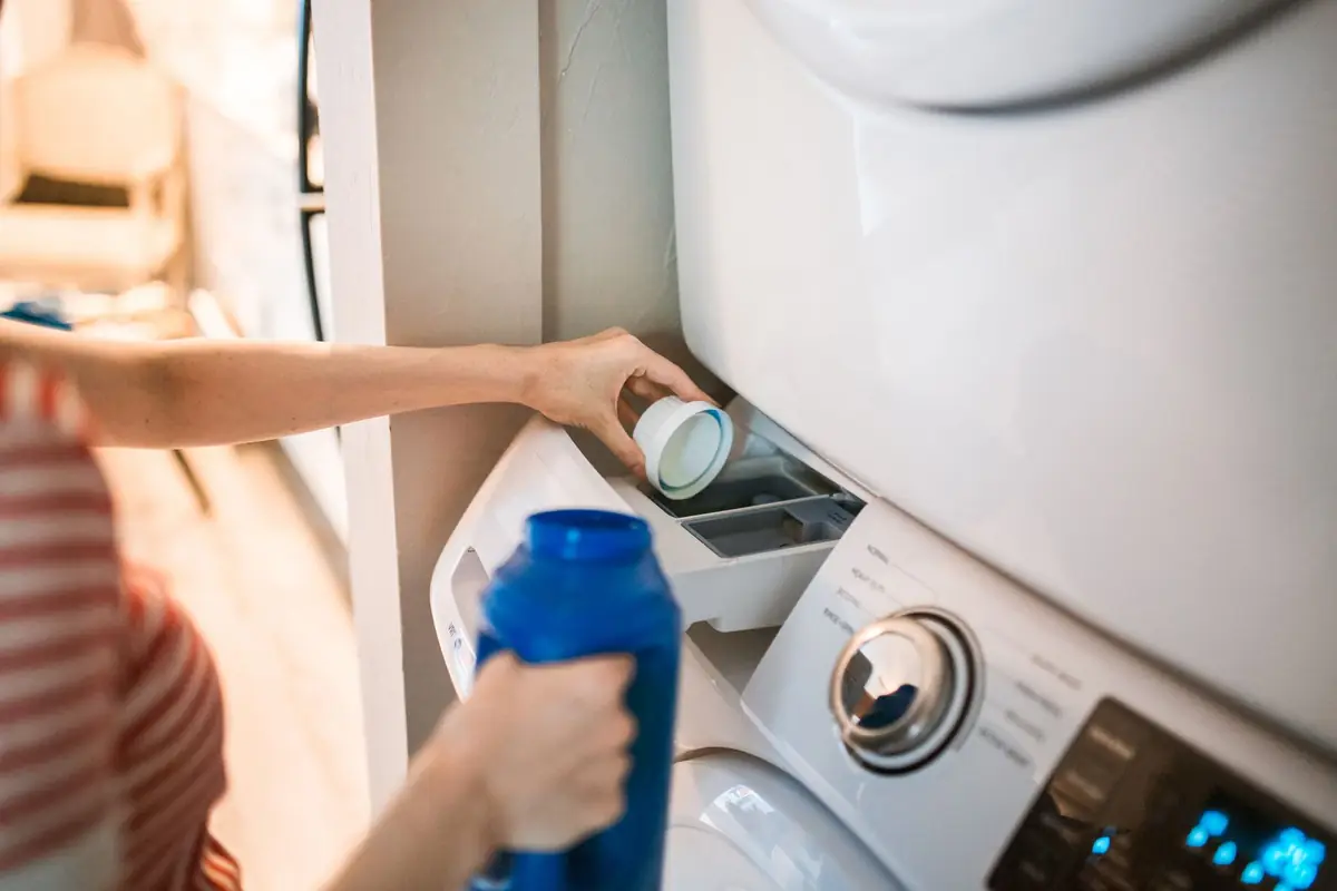 Pouring liquid detergent into the dispenser of a front-load washer