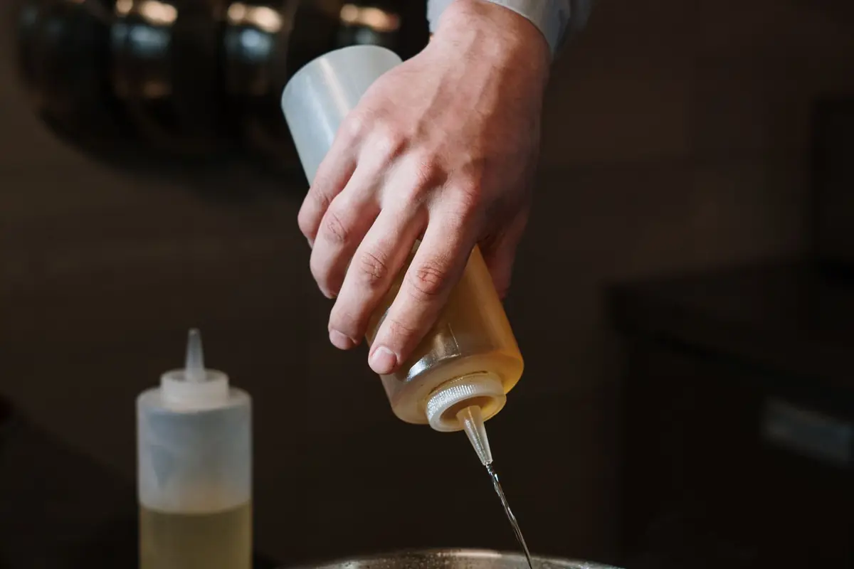 Pouring cooking oil from a squeeze bottle