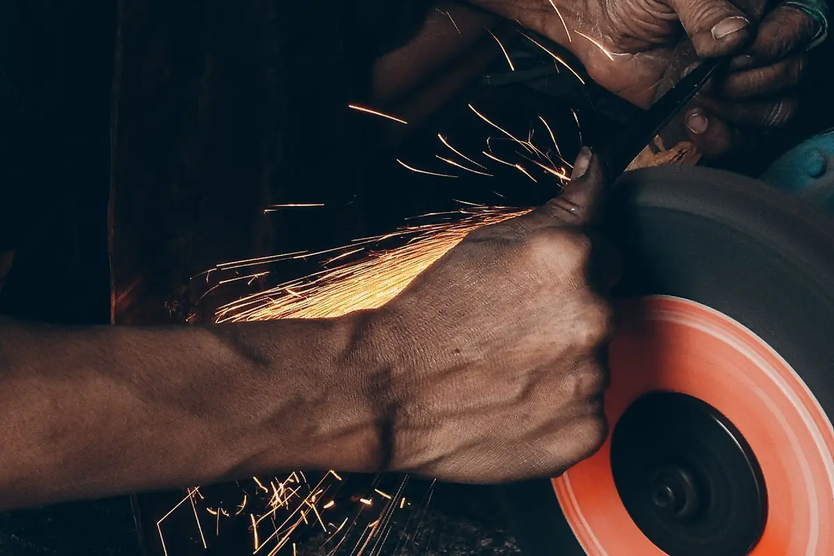 Sparks flying as metal is sharpened on a grinding wheel