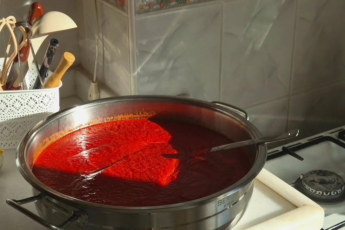 A large pot of tomato sauce simmering on a stove