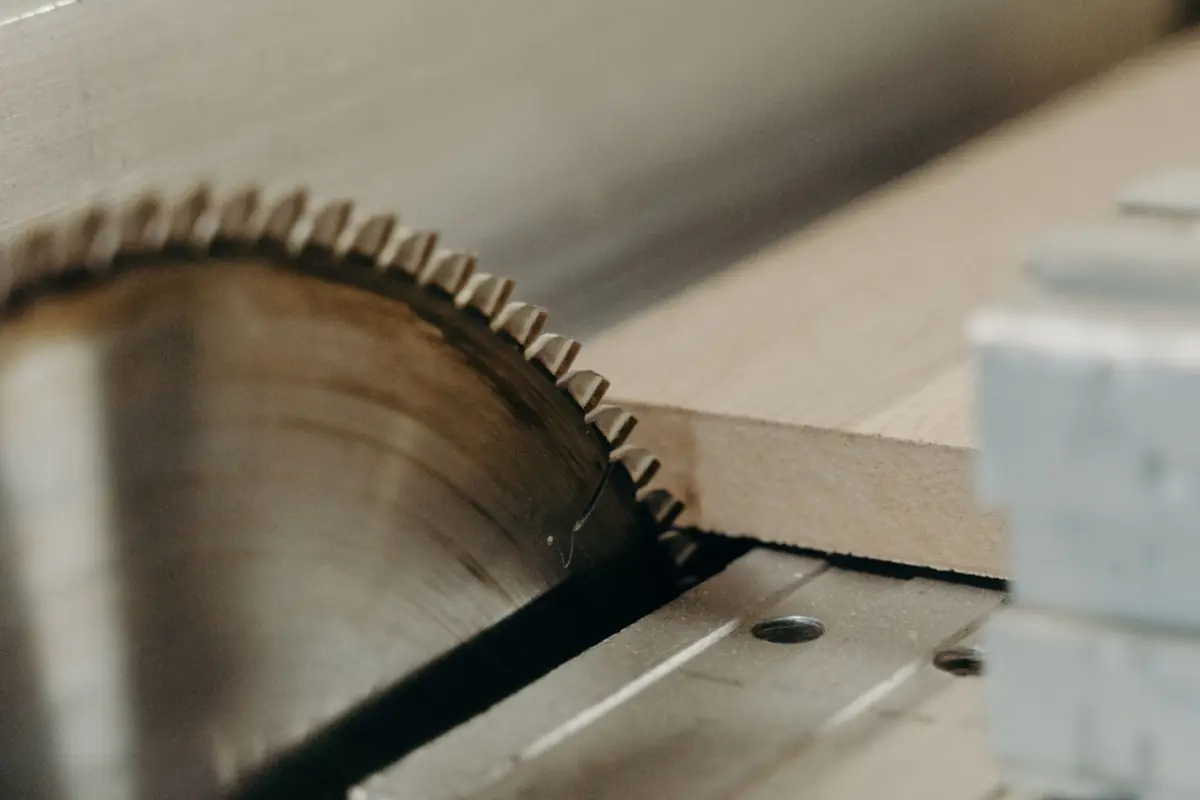 A table saw blade rising through the table