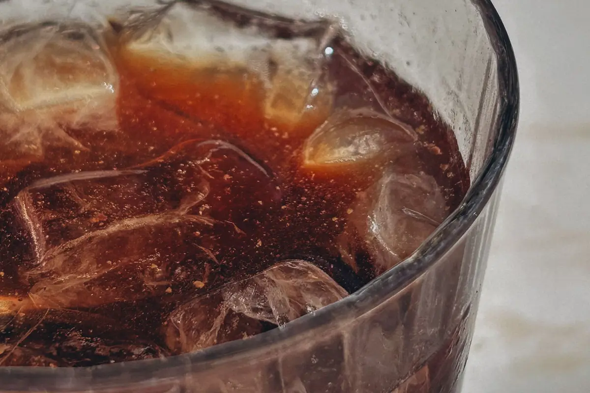 Close-up of ice cubes in a glass of cola
