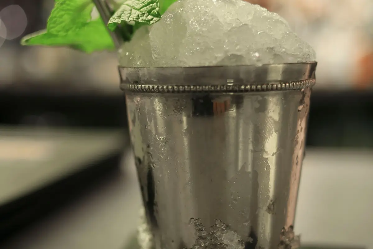 A mint julep cup heaped with crushed ice