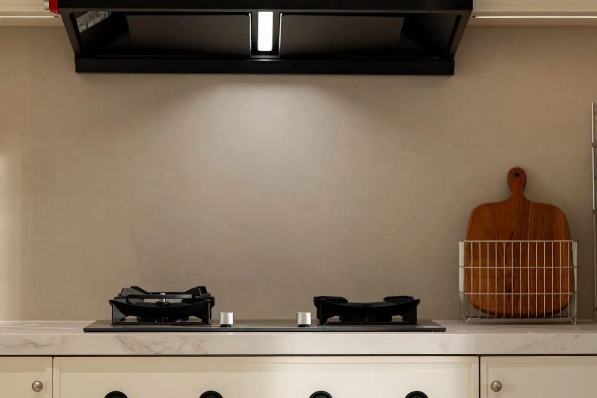 A two-burner cooktop under a black range hood
