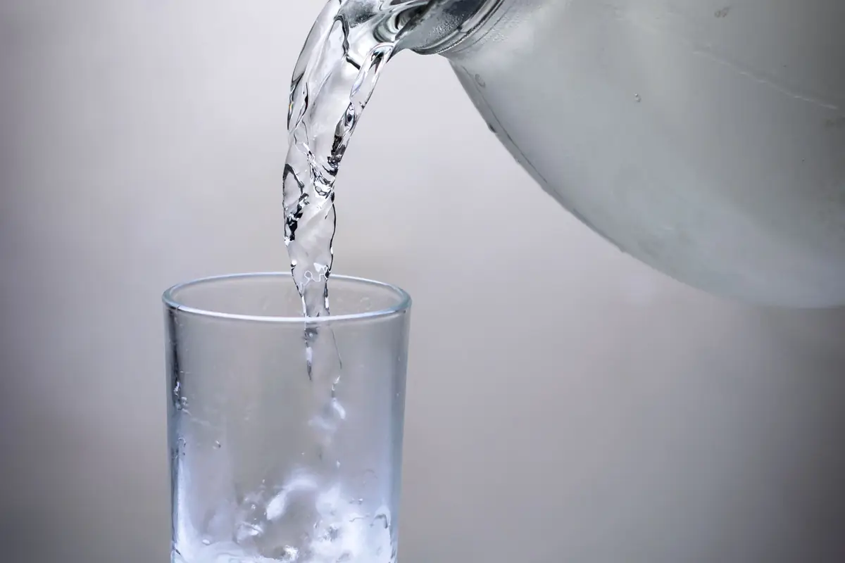 Water being poured into a drinking glass
