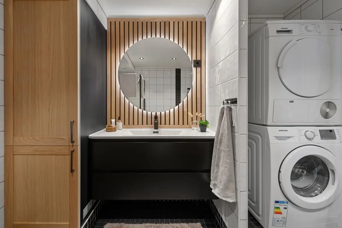 A stacked washer and dryer in a modern bathroom
