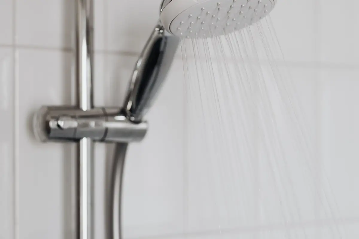 A shower head on a slide bar spraying water
